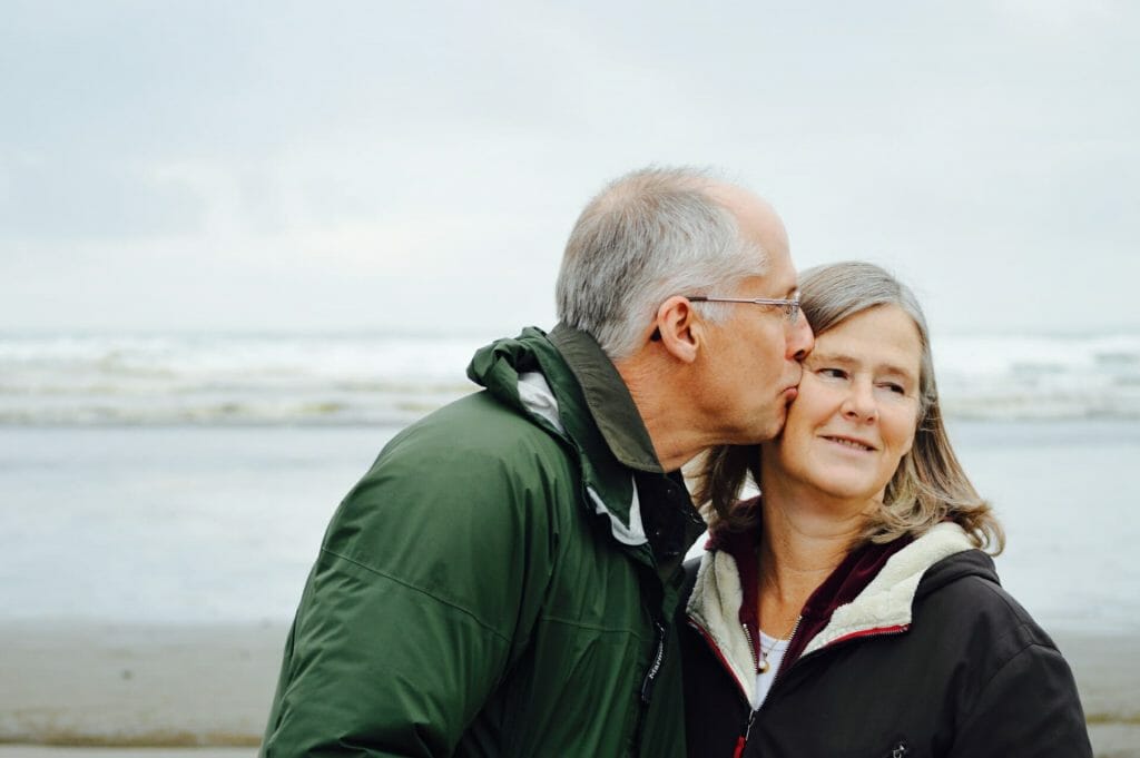 An affectionate, senior couple on the beach